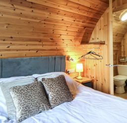 A bedroom with a bed and attached bathroom at Garden Lodge 4 Swansea