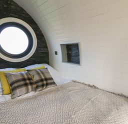 A bedroom with a bed and pillows at Garden Lodge 10 Swansea