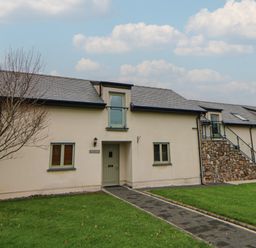 A building with stone steps and windows at Willow Apartment in Swansea