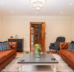 A living room with sofas and a coffee table at Knowle House in Okehampton