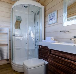 A bathroom with a shower, toilet, and sink at Chestnut Spa (Pet) Carlton Miniott near Thirsk