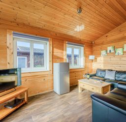 A living room with a fridge and a tv at Yew Tree Spa (Pet) Carlton Miniott near Thirsk