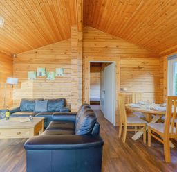 A living room with a sofa and dining table at Yew Tree Spa (Pet) Carlton Miniott near Thirsk