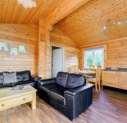 A living room with a sofa and dining area at Yew Tree Spa (Pet) in Carlton Miniott near Thirsk