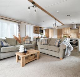 A living room with sofas and a coffee table at Juniper Waterside Spa Carlton Miniott near Thirsk