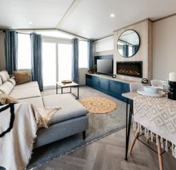 A living room with a sofa and coffee table at Rowan Waterside Spa, Carlton Miniott near Thirsk
