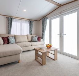 A living room with a sofa and coffee table at Ellery Waterside Spa Carlton Miniott near Thirsk