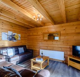 A living room with a sofa and coffee table at Birch Waterside Spa Carlton Miniott near Thirsk