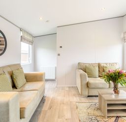 A living room with a sofa and coffee table at Cedar Spa in Carlton Miniott near Thirsk
