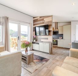A living room with a television and a dining area at Cedar Spa in Carlton Miniott near Thirsk