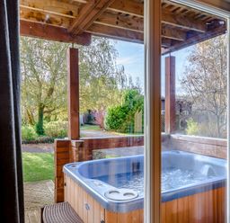 A view of a hot tub from a window at Birch Spa (Pet) Carlton Miniott near Thirsk