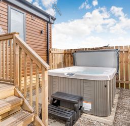 An outdoor area with a hot tub and steps at Kinder Spa in Carlton Miniott near Thirsk