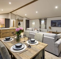 A living room with a dining table and sofa at Laurel Spa in Carlton Miniott near Thirsk