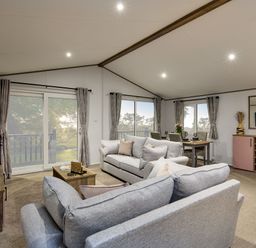 A living room with a sofa and dining table at Laurel Spa Carlton Miniott near Thirsk
