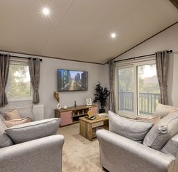 A living room with a sofa and television at Laurel Spa in Carlton Miniott near Thirsk