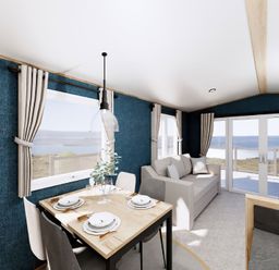 A dining room with a table and sofa at Willow Spa near Carlton Miniott