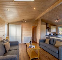 A living room with sofas and a coffee table at Fir Tree Waterside Spa in Carlton Miniott near Thirsk