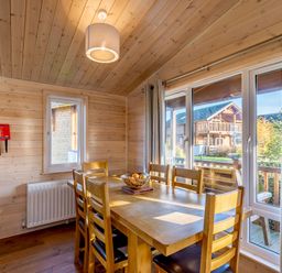 A dining room with a table and chairs at Fir Tree Waterside Spa in Carlton Miniott near Thirsk