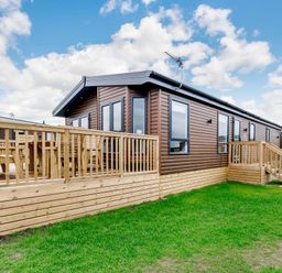 A cabin with wooden decking and steps at Beech Waterside Spa (Pet) Carlton Miniott near Thirsk