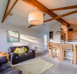 A living room with a sofa and dining area at Cherry Tree Carlton Miniott near Thirsk