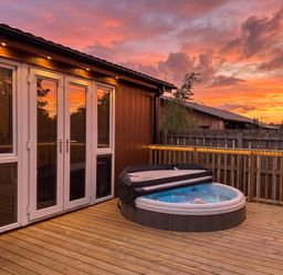 A hot tub on a deck at Cherry Tree Spa Carlton Miniott near Thirsk