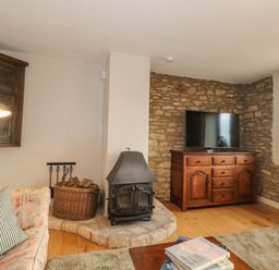 A living room with a television and fireplace at Daisy Bank Maugersbury near Stow-On-The-Wold