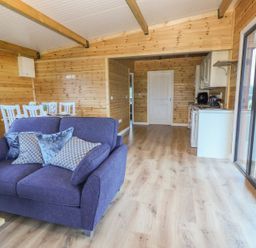 A living room with a sofa and dining area at Killinure Cottage in Glasson, County Westmeath