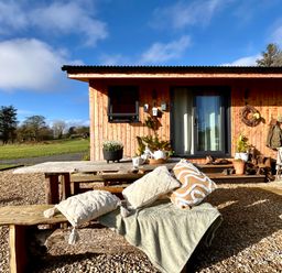 An outdoor seating area with a table and chairs at Harriet in Llangurig