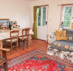 A dining room with a table and chairs at The Hare & the Bumblebee Cottage