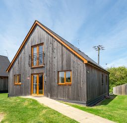 A house with wooden exterior and balcony at Aspen Lodge Near Brigg
