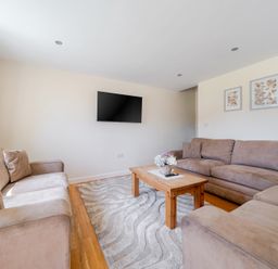 A living room with a television and a coffee table at Aspen Lodge Near Brigg