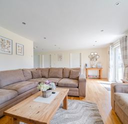 A living room with a sofa and coffee table at Aspen Lodge Near Brigg