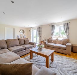 A living room with a sofa and coffee table at Aspen Lodge Near Brigg