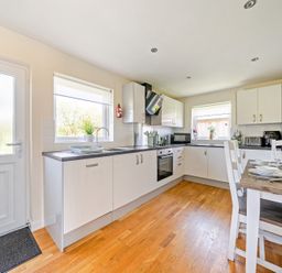 A kitchen with a dining table and appliances at Sage Lodge Near Brigg