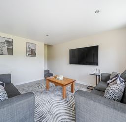 A living room with a television and coffee table at Raven Lodge Near Brigg