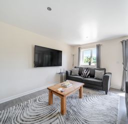 A living room with a sofa and coffee table at Raven Lodge Near Brigg