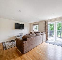 A living room with a sofa and television at Paddington Lodge near Brigg