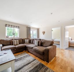 A living room with a sofa and television at Paddington Lodge near Brigg