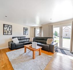 A living room with a sofa and coffee table at Charcoal Lodge in Brigg