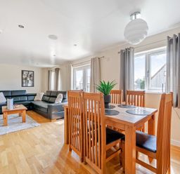 A living room with a dining area and sofa at Charcoal Lodge in Brigg