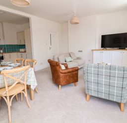 A living room with a sofa and dining table at The Old Bank Flat in North Tawton