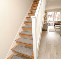 A staircase with carpeted steps leading to a living area at Harbour View Poole