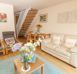 A living room with sofas and a dining table at Poole Quay Cottage in Poole