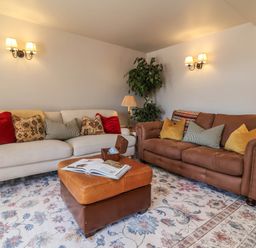 A living room with two sofas and a coffee table at Captains Barn Tiverton