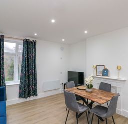 A dining room with a table and chairs at Beachwalk Villa 2 in Whitby