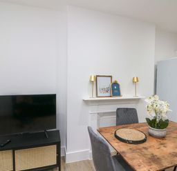 A dining room with a table and chairs at Beachwalk Villa 2 in Whitby
