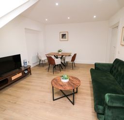 A living room with a sofa and coffee table at Beachwalk Villa 3 in Whitby