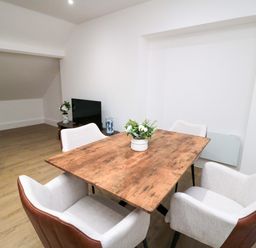 A dining room with a table and chairs at Beachwalk Villa 3 in Whitby