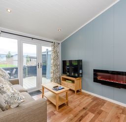 A living room with a sofa and television at Coniston (Pet) Penrith