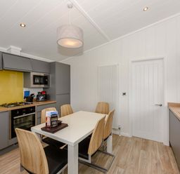 A kitchen with a table and chairs at Blencathra Family in Penrith